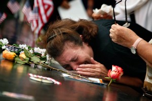 A woman mourns the loss of her son at the World Trade Center Memorial during ceremonies marking the 10th anniversary of the 9/11 attacks on the World Trade Center, in New York