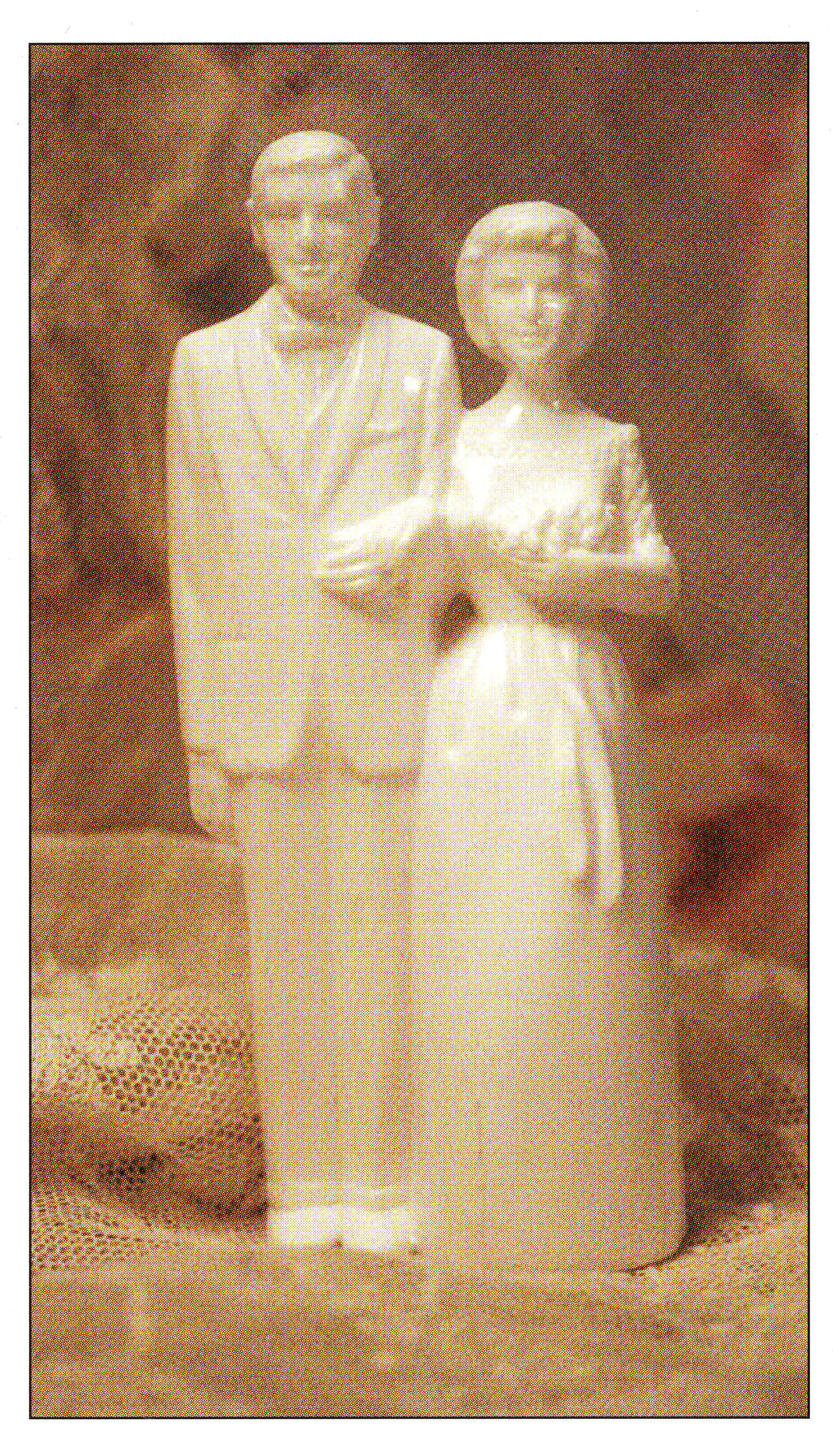A white, completely unpainted bride and groom wedding cake topper