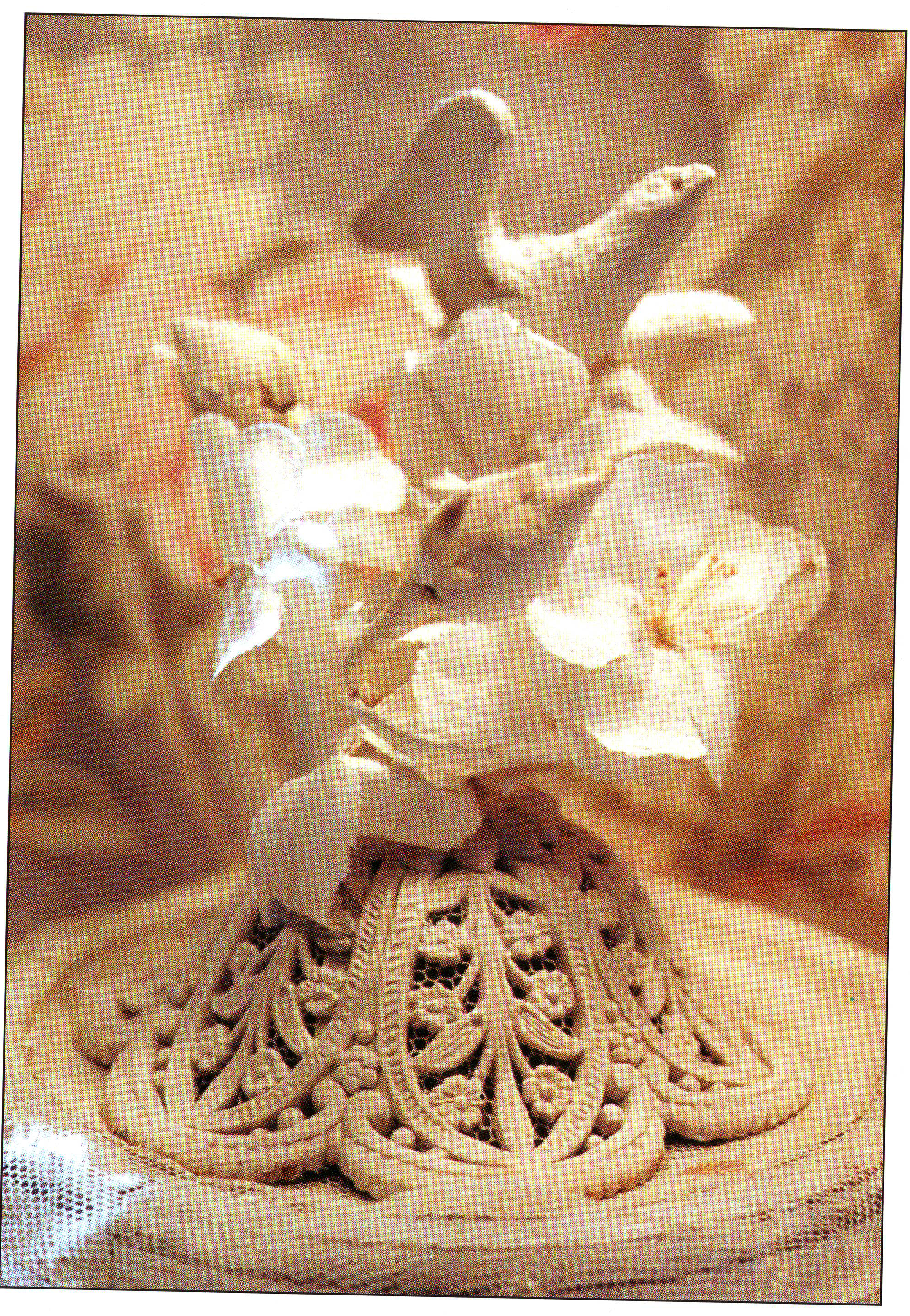 A modeled dove on a spray of flowers above a lace-like domed base