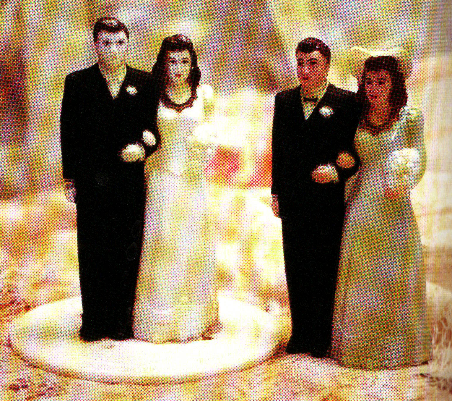Two identical sets of bride and groom with painted variations in skin and clothing color.